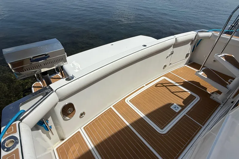 Slide: The Image of 1996 Carver 400 Cockpit Motor Yacht with teak deck and stainless steel grill by the water. - 10