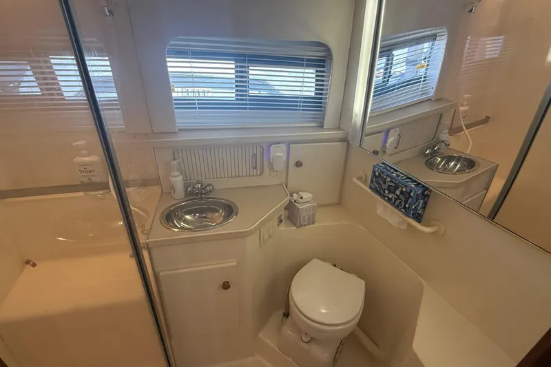 Slide: The Image of Bathroom interior of 1996 Carver 400 Cockpit Motor Yacht with sink and toilet. - 44