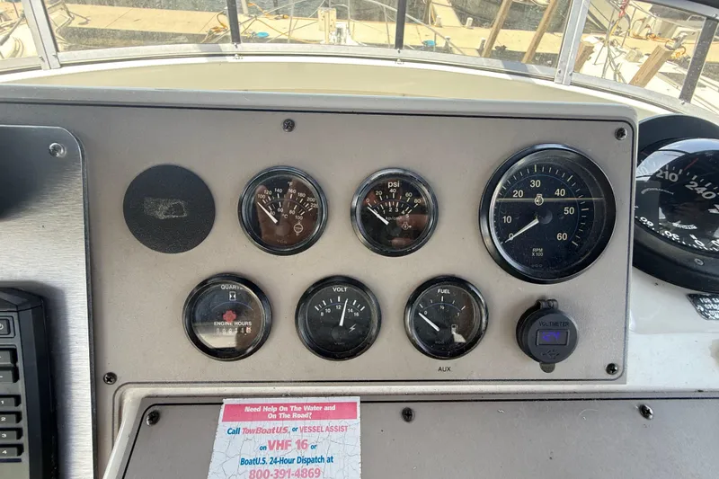 Slide: The Image of Dashboard of a 1996 Carver 400 Cockpit Motor Yacht with gauges and controls. - 25