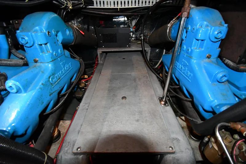 Slide: The Image of Engine room of the 1996 Carver 400 Cockpit Motor Yacht with blue engines. - 46