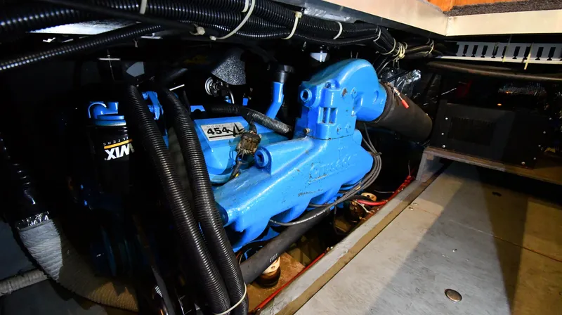 Slide: The Image of Engine room of a 1996 Carver 400 Cockpit Motor Yacht with a blue engine. - 48