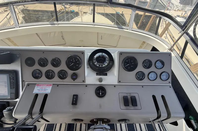Slide: The Image of Control panel of a 1996 Carver 400 Cockpit Motor Yacht with gauges and navigation instruments. - 26