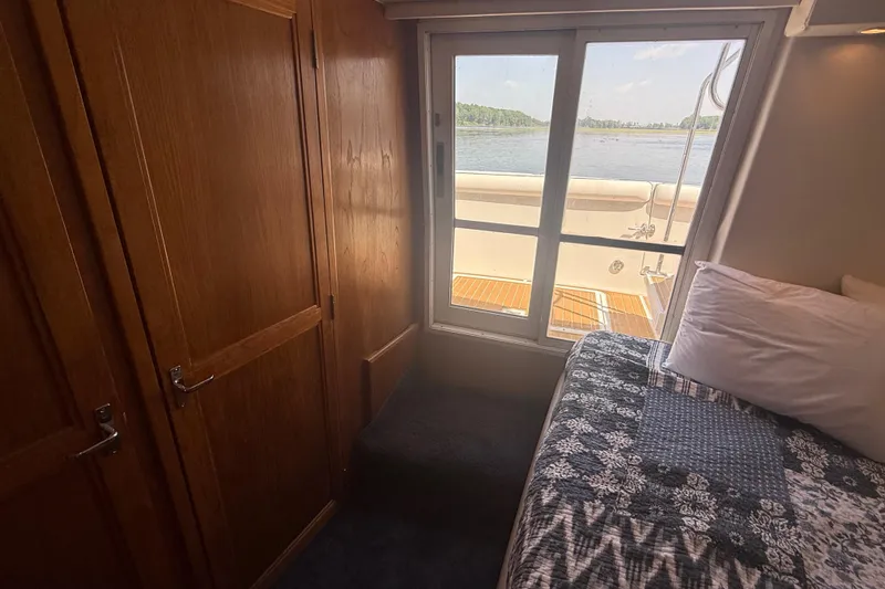 Slide: The Image of Cozy cabin interior of 1996 Carver 400 Cockpit Motor Yacht with scenic water view. - 42