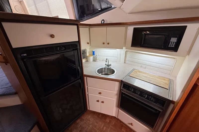 Slide: The Image of Compact kitchen in a 1996 Carver 400 Cockpit Motor Yacht with modern appliances. - 36