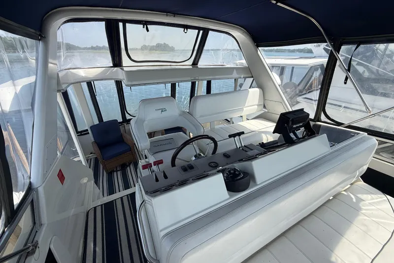 Slide: The Image of 1996 Carver 400 Cockpit Motor Yacht interior with helm, seating, and navigation equipment. - 20