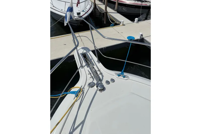 Slide: The Image of Bow view of 1996 Carver 400 Cockpit Motor Yacht docked at marina. - 6