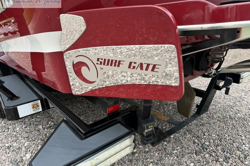 Slide: The Image of 2014 Malibu Wakesetter 24 MXZ with Surf Gate technology, red and white design. - 4