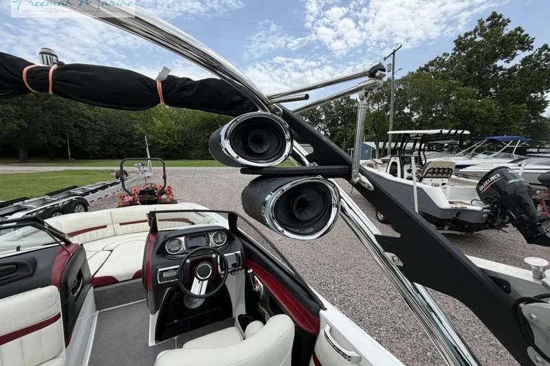 Slide: The Image of 2014 Malibu Wakesetter 24 MXZ boat interior with speakers and steering wheel. - 21