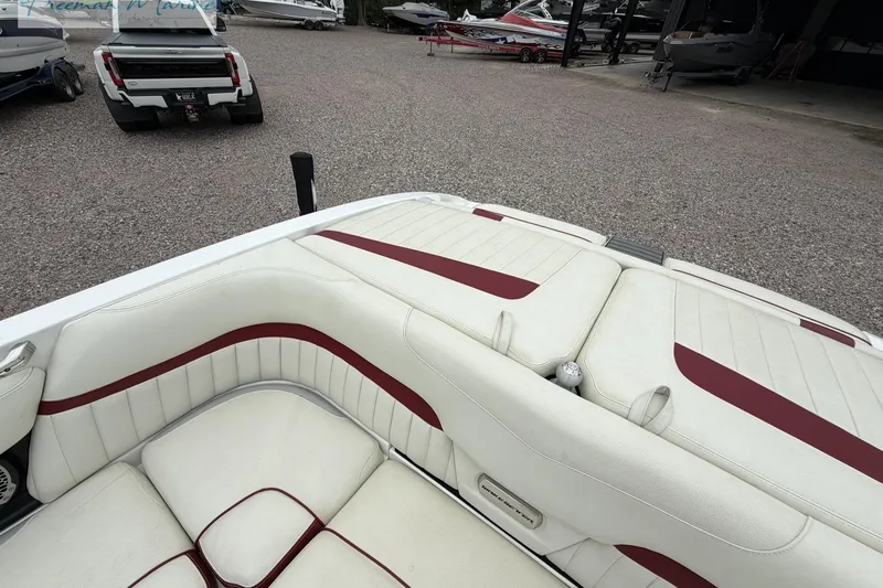 Slide: The Image of 2014 Malibu Wakesetter 24 MXZ boat interior with white and red seating. - 17