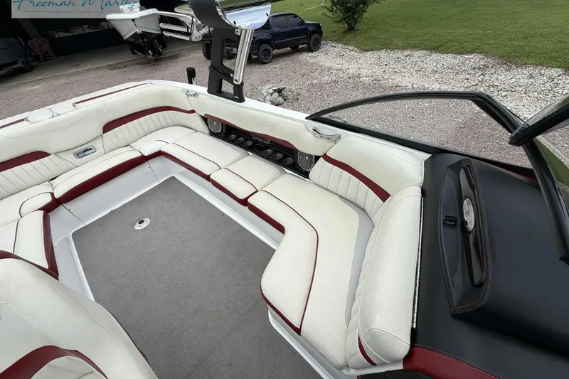 Slide: The Image of 2014 Malibu Wakesetter 24 MXZ interior with white and red seating, spacious layout. - 13