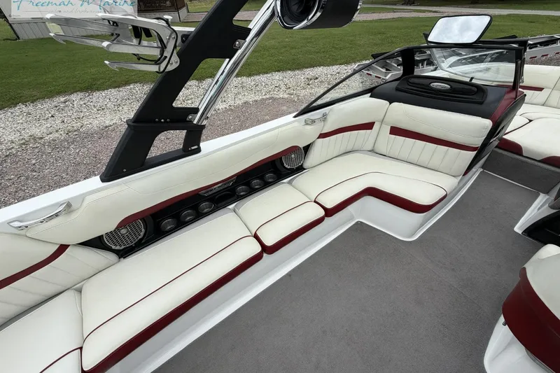 Slide: The Image of 2014 Malibu Wakesetter 24 MXZ interior with white and red seating, sleek design. - 24