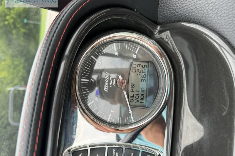 Slide: The Image of Close-up of 2014 Malibu Wakesetter 24 MXZ dashboard gauge displaying oil PSI and voltage. - 33