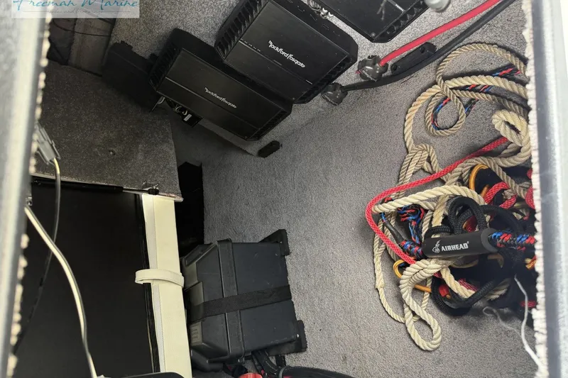 Slide: The Image of Storage compartment of 2014 Malibu Wakesetter 24 MXZ with ropes and equipment. - 10