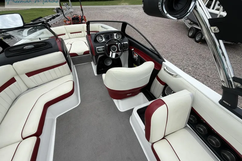 Slide: The Image of 2014 Malibu Wakesetter 24 MXZ interior with white and red seating, sleek dashboard, and spacious layout. - 20