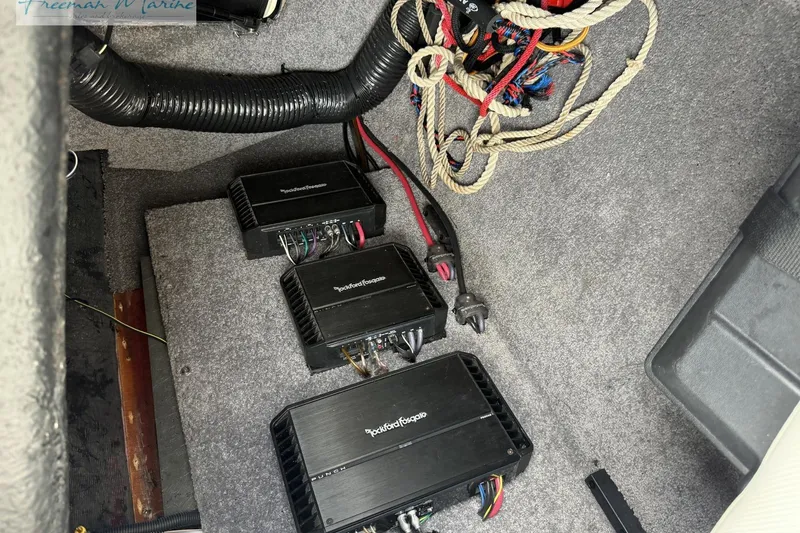 Slide: The Image of 2014 Malibu Wakesetter 24 MXZ interior with Rockford Fosgate amplifiers and wiring. - 30