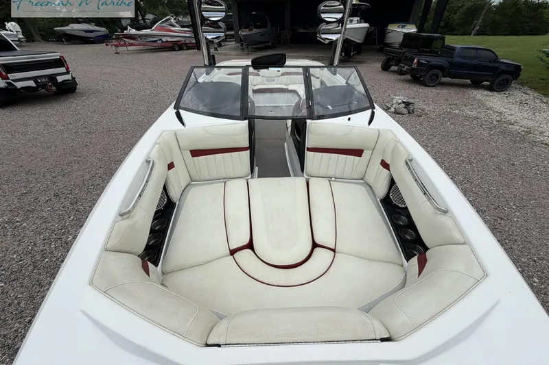 Slide: The Image of 2014 Malibu Wakesetter 24 MXZ boat with spacious white and red interior seating. - 9