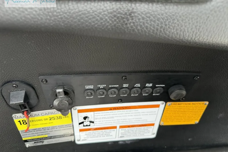 Slide: The Image of Control panel of a 2014 Malibu Wakesetter 24 MXZ boat with warning labels. - 31