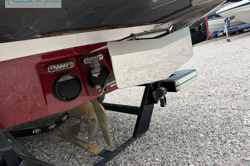 Slide: The Image of 2014 Malibu Wakesetter 24 MXZ boat stern with propeller and trim tabs. - 5