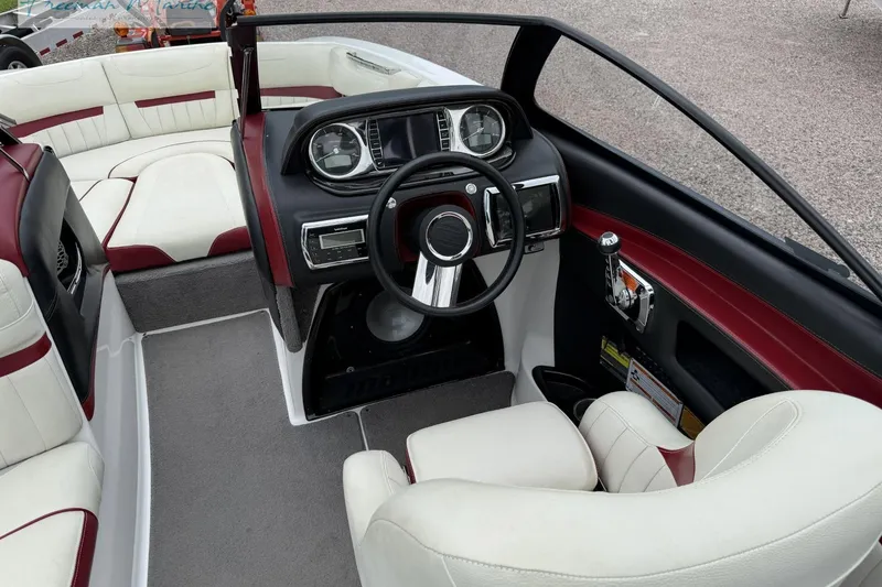 Slide: The Image of 2014 Malibu Wakesetter 24 MXZ boat interior with steering wheel and seating. - 26