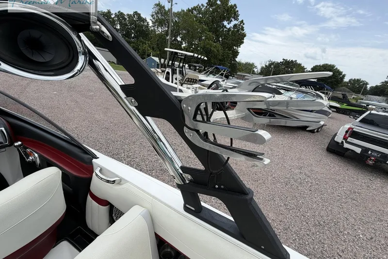 Slide: The Image of 2014 Malibu Wakesetter 24 MXZ boat interior with speaker and wakeboard rack. - 22