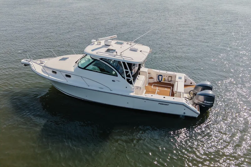 Slide: The Image of 2013 Pursuit OS 345 Offshore boat on calm water, featuring twin Yamaha engines. - 3