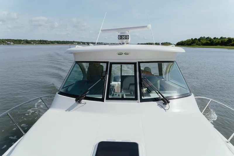 Slide: The Image of 2013 Pursuit OS 345 Offshore boat cruising on calm waters. - 9