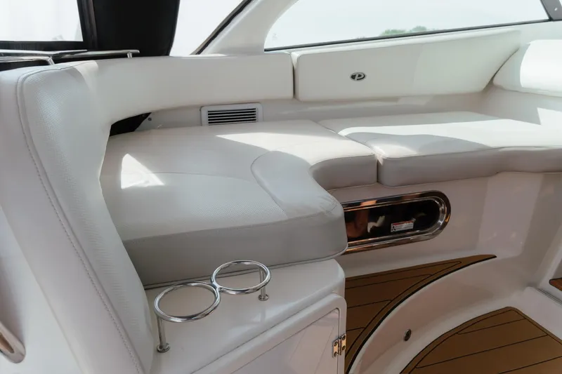 Slide: The Image of 2013 Pursuit OS 345 Offshore boat interior with white seating and cup holders. - 8