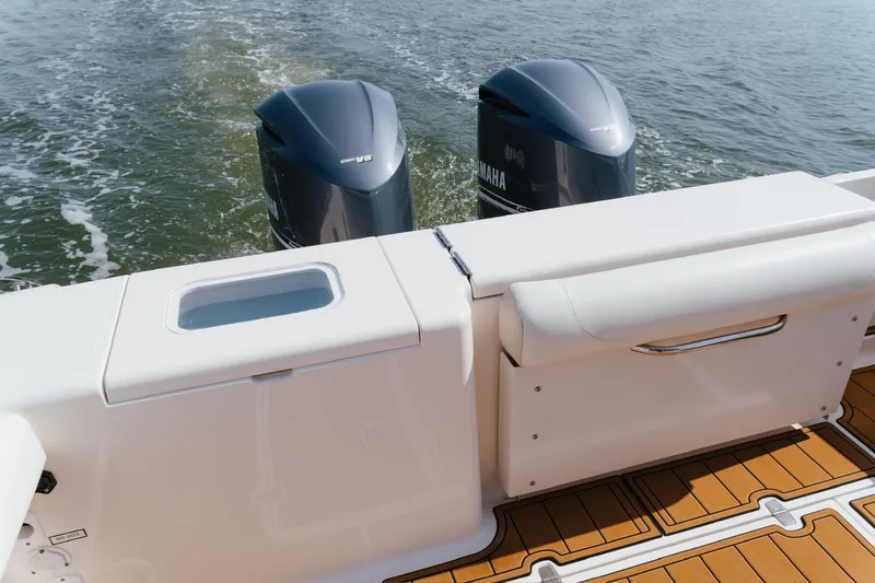Slide: The Image of 2013 Pursuit OS 345 Offshore boat with twin Yamaha V8 engines on water. - 6