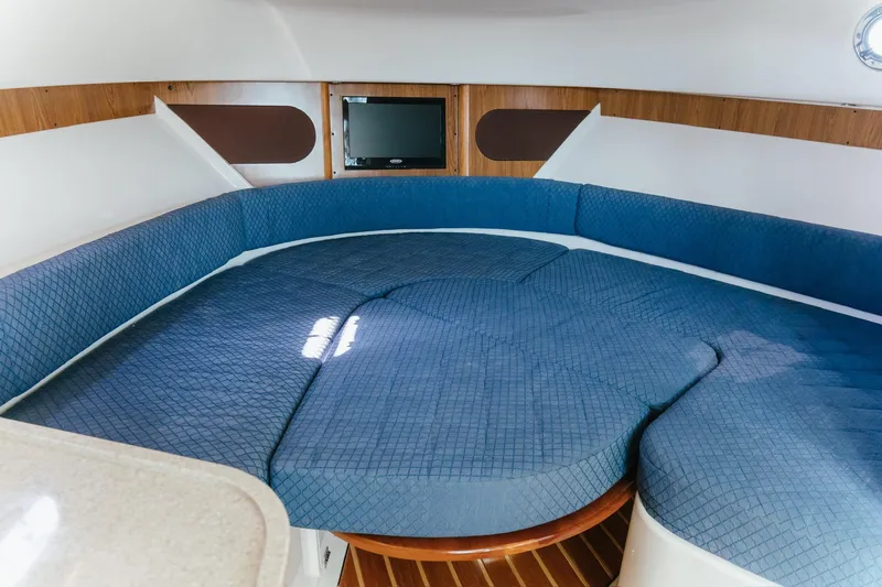 Slide: The Image of Interior of 2013 Pursuit OS 345 Offshore boat with blue cushioned seating. - 15