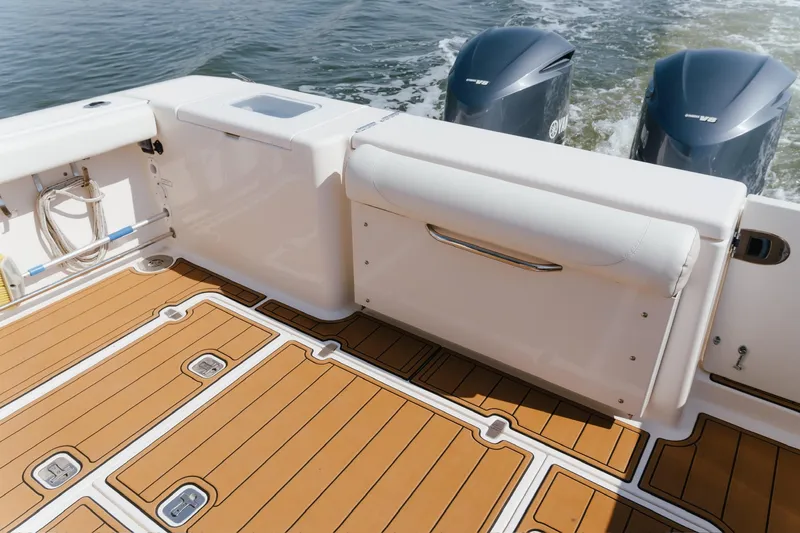 Slide: The Image of 2013 Pursuit OS 345 Offshore boat deck with twin Yamaha engines. - 11