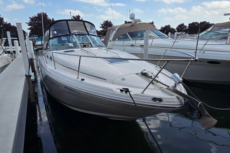 Slide: The Image of 2002 Sea Ray 300 Sundancer docked at marina under clear skies. - 3