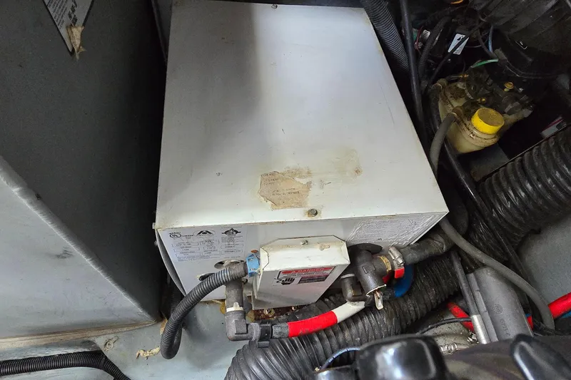 Slide: The Image of Engine compartment of 2002 Sea Ray 300 Sundancer with visible mechanical components. - 36