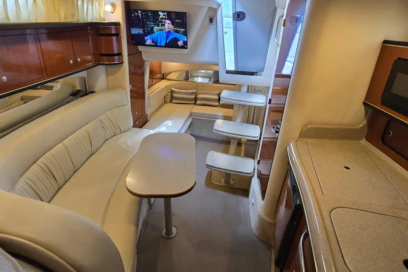 Slide: The Image of Interior of 2002 Sea Ray 300 Sundancer yacht with cozy seating and modern amenities. - 26