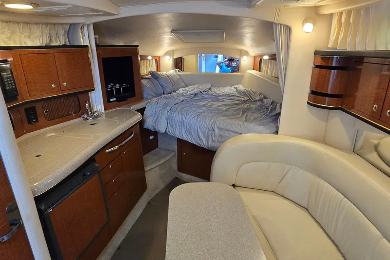 Slide: The Image of Luxurious interior of 2002 Sea Ray 300 Sundancer yacht with cozy bed and kitchenette. - 27