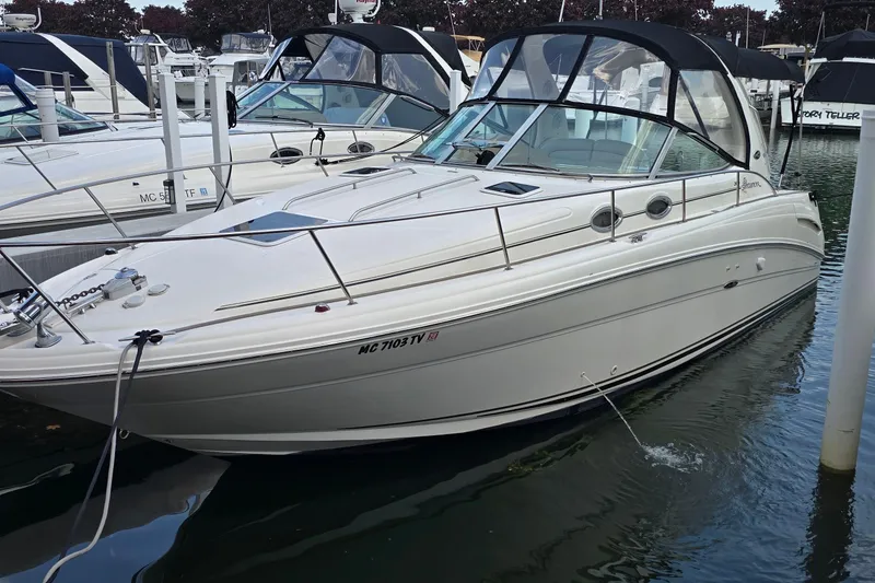 The Image of 2002 Sea Ray 300 Sundancer boat docked in marina, featuring sleek design and white exterior. - 1