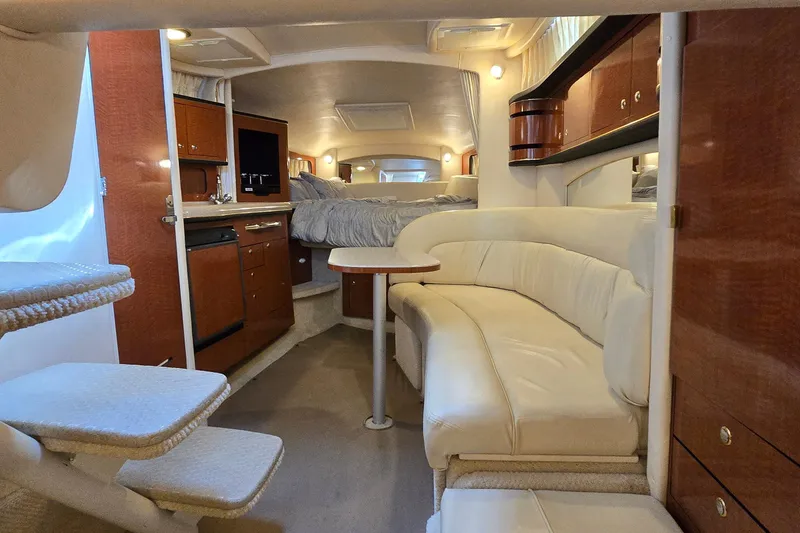 Slide: The Image of Luxurious interior of a 2002 Sea Ray 300 Sundancer yacht with elegant seating and cabinetry. - 29