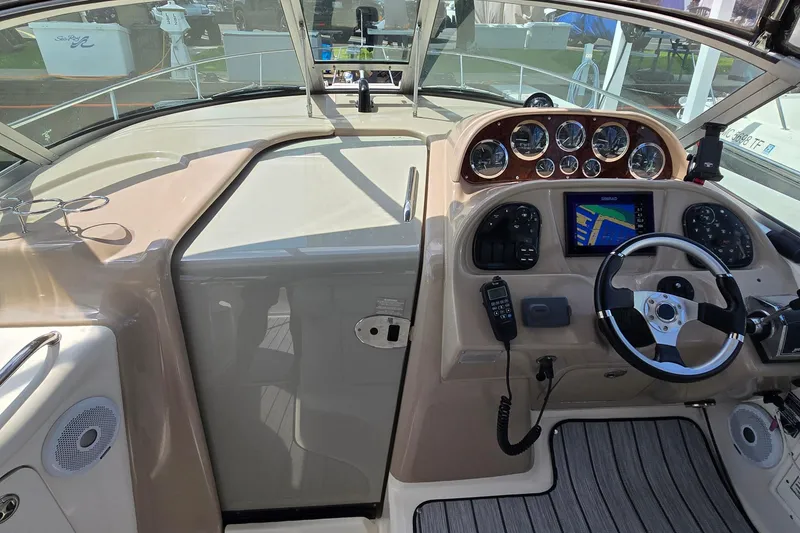Slide: The Image of 2002 Sea Ray 300 Sundancer helm with gauges, GPS, and steering wheel. - 12