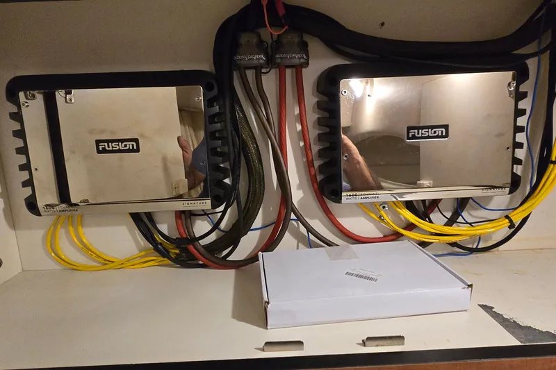 Slide: The Image of Fusion amplifiers installed on a 2002 Sea Ray 300 Sundancer boat, with visible wiring. - 28