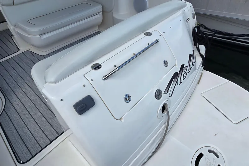 Slide: The Image of 2002 Sea Ray 300 Sundancer boat interior with cushioned seating and deck details. - 6