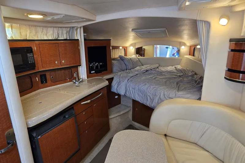 Slide: The Image of Interior of 2002 Sea Ray 300 Sundancer with kitchenette and cozy sleeping area. - 17