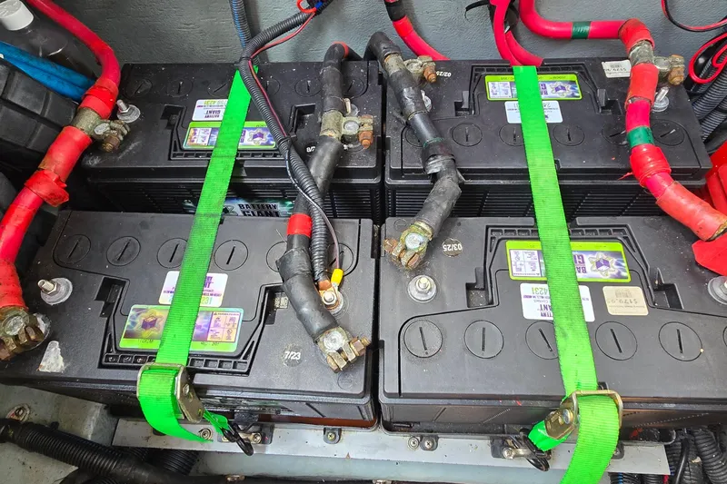 Slide: The Image of Battery setup in a 2002 Sea Ray 300 Sundancer boat with secured connections. - 35