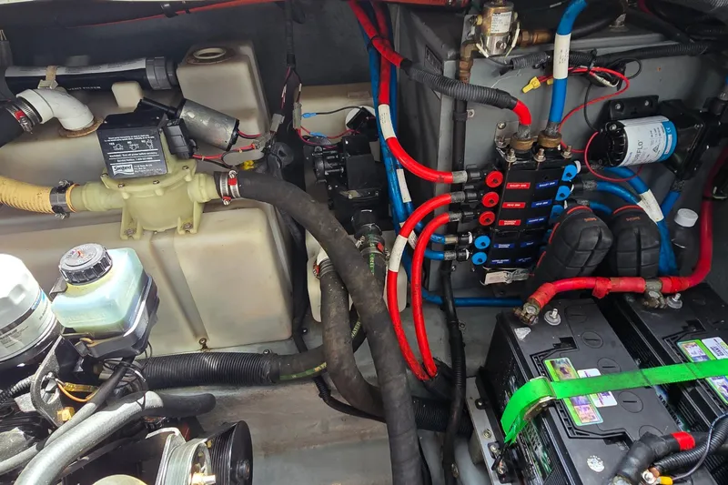 Slide: The Image of Engine compartment of a 2002 Sea Ray 300 Sundancer with wiring and components. - 33