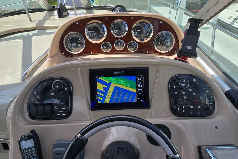 Slide: The Image of Dashboard of a 2002 Sea Ray 300 Sundancer with navigation system and gauges. - 13