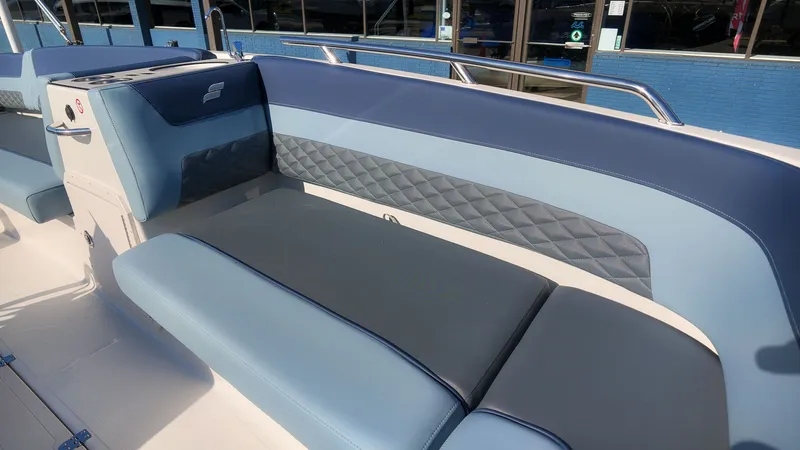 Slide: The Image of The 2027 Starcraft SVX 211 OB features a stylish, cushioned bench seat with blue and gray accents. - 18