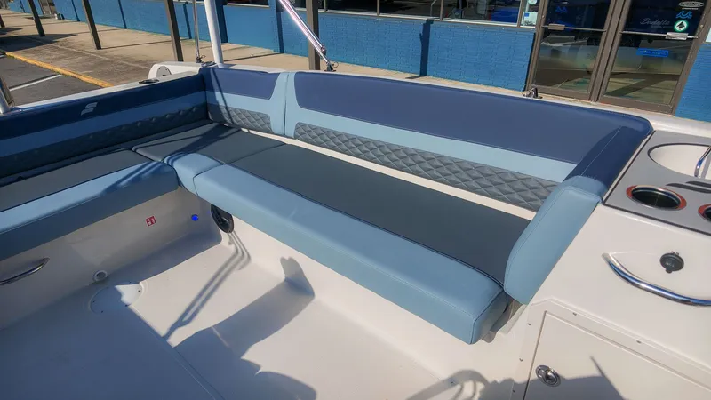 Slide: The Image of The image shows the seating area of a Starcraft SVX 211 OB boat with blue upholstery. - 13
