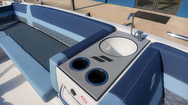 Slide: The Image of The image shows the cockpit of a Starcraft SVX 211 OB with blue seating and a sink. - 15