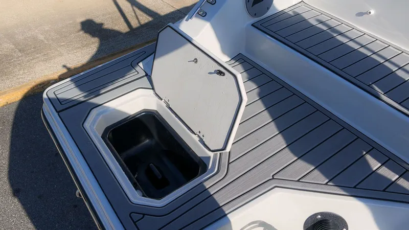 Slide: The Image of The image shows the deck of a Starcraft SVX 211 OB boat with an open storage hatch. - 7