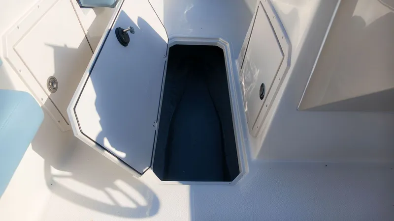 Slide: The Image of Floor storage compartment on a Starcraft SVX 211 OB boat with an open hatch. - 17