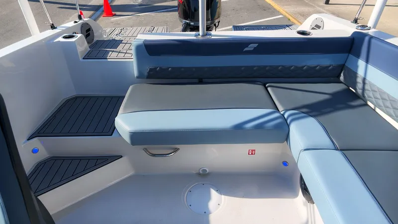 Slide: The Image of The image shows the seating area of a Starcraft SVX 211 OB boat with blue upholstery. - 10