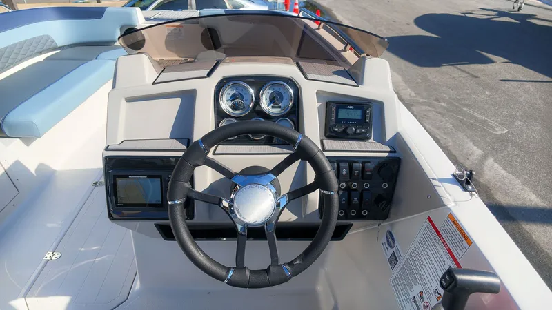 Slide: The Image of The image shows the helm of a Starcraft SVX 211 OB boat with modern instruments. - 21